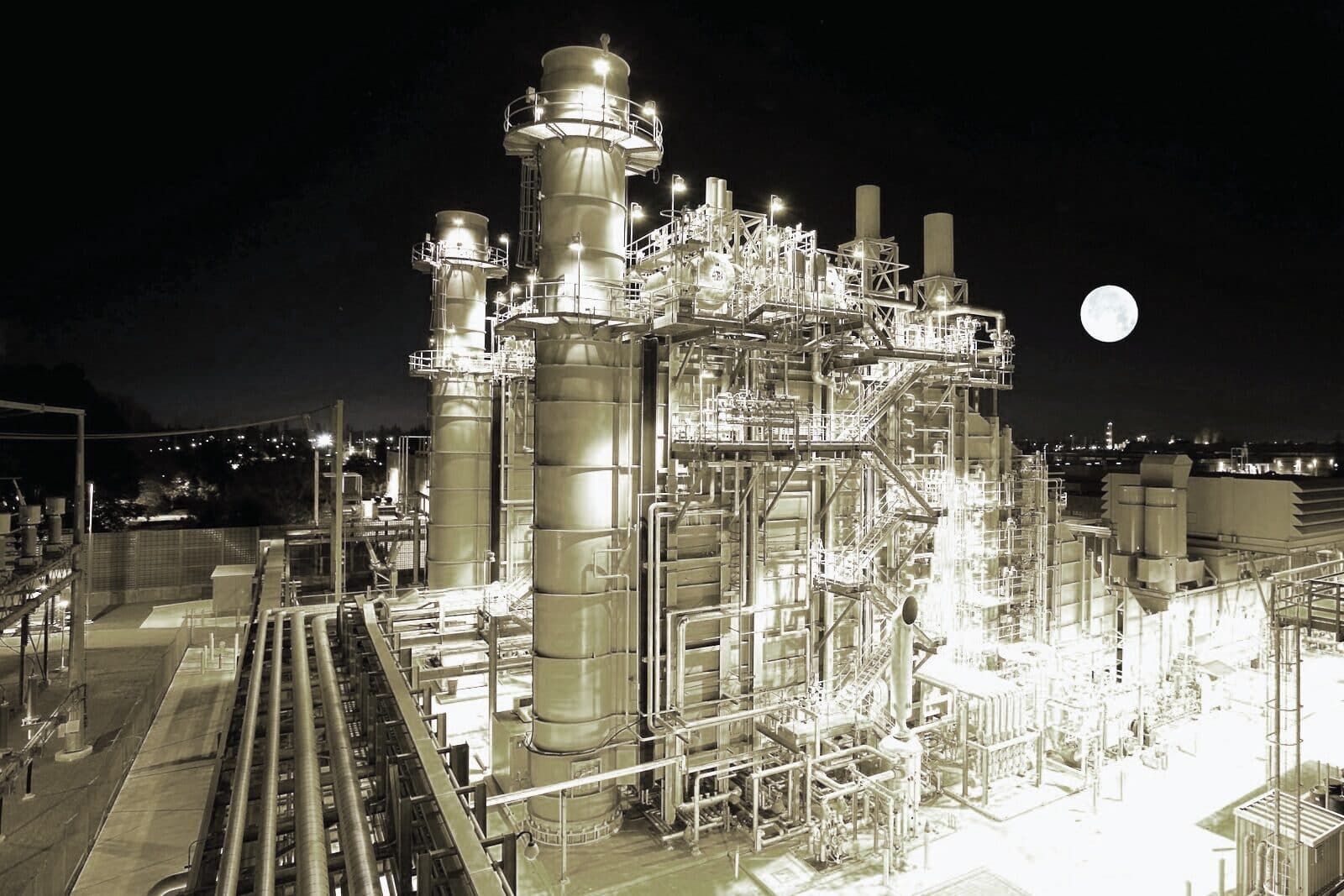 A process plant lit up against the night sky